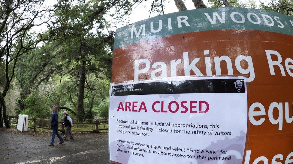 Hikers walk out of a closed Muir Woods National Monument, part of California's Golden Gate National Recreation Area,