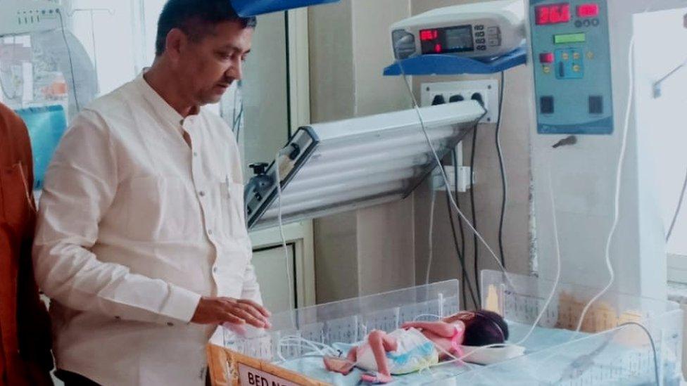 Local politician Rajesh Kumar Mishra with the baby in hospital