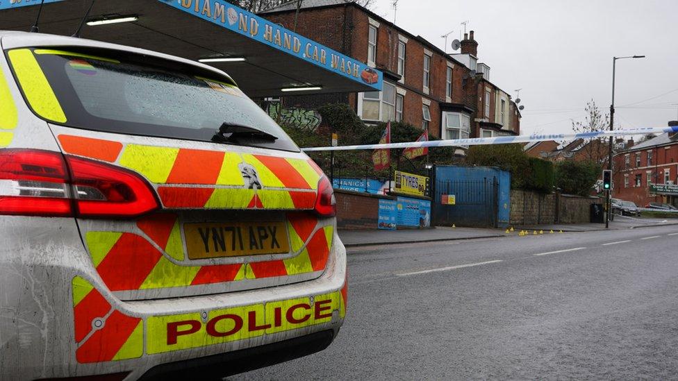 A police car and cordon at scene