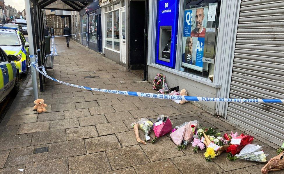 Flowers left by the area sectioned off by police