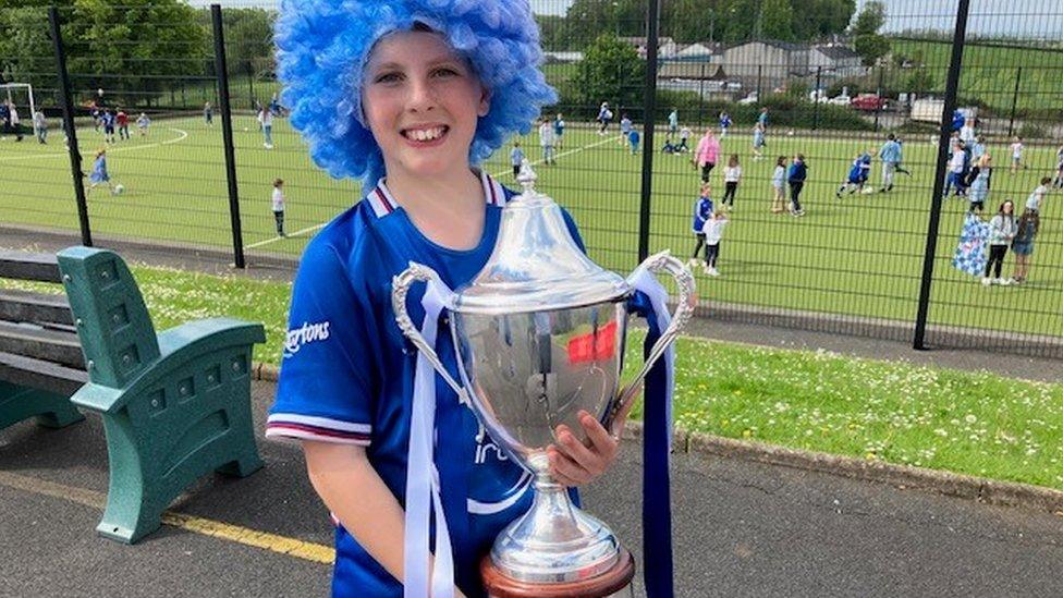 Loughgall youth team player Sophie holding the championship trophy.