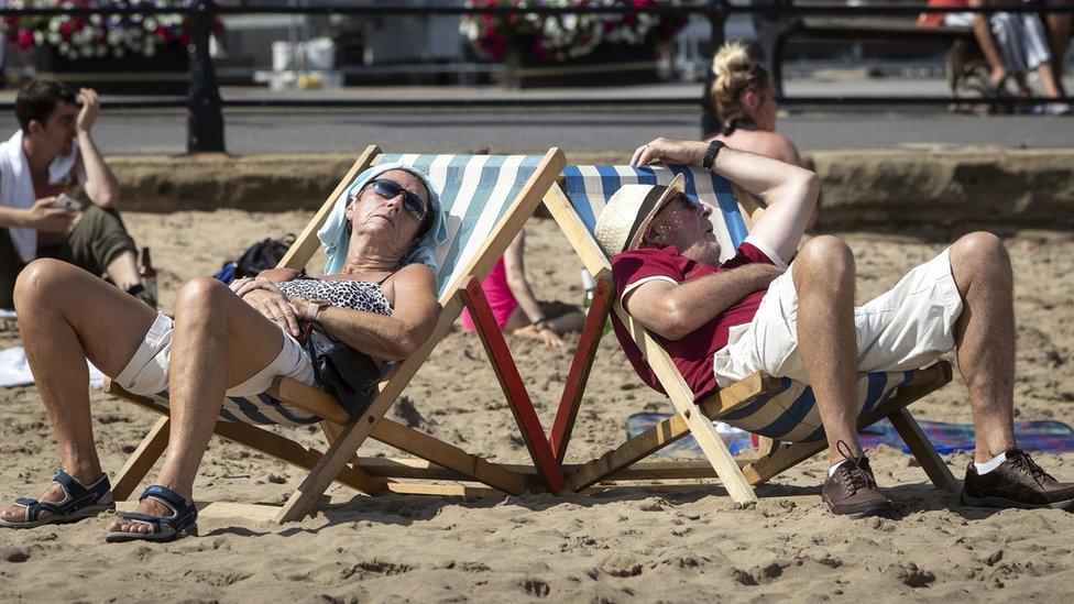 People sunbathe on Scarborough beach