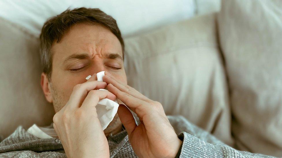 Man blowing his nose