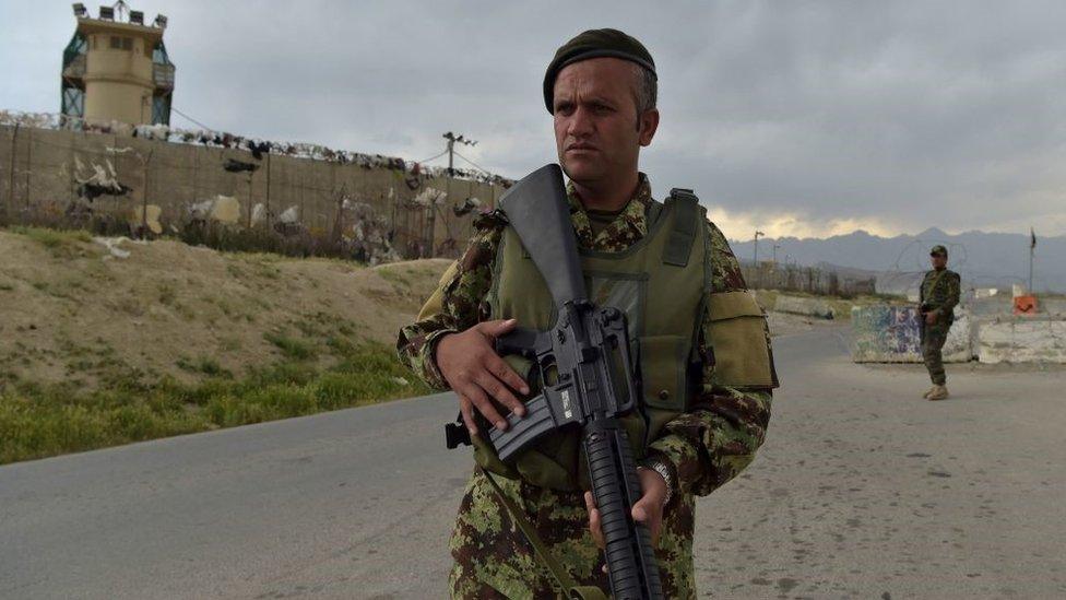 Afghan National Army (ANA) soldiers stand guard at a checkpoint outside a US military base in Bagram in April 2021