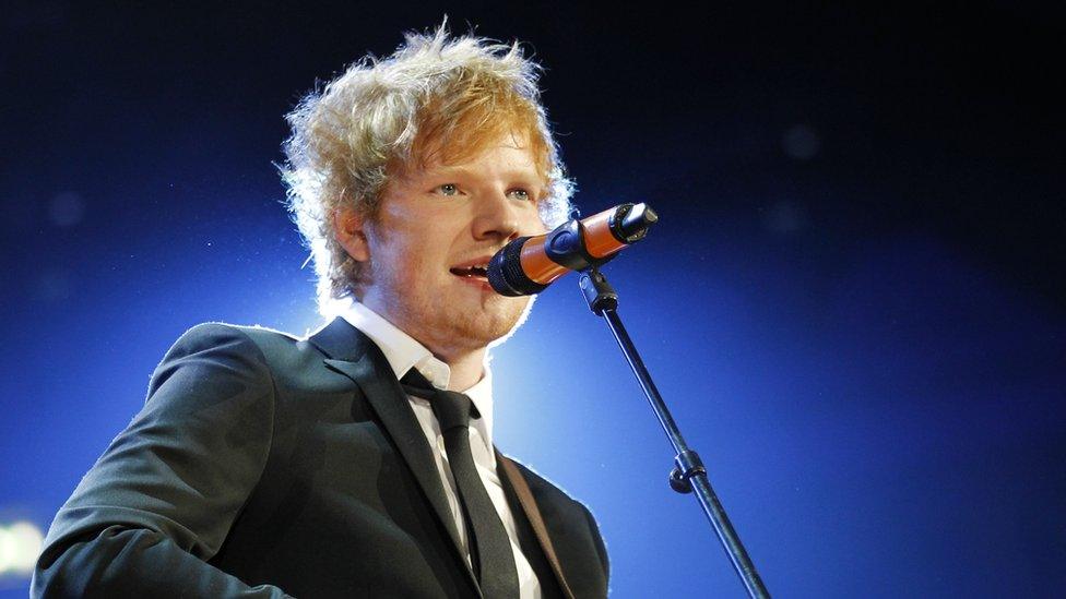 Ed Sheeran singing on stage