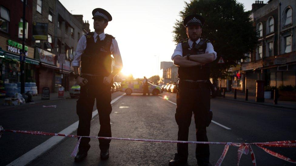 Police guard a street in Finsbury Park after a vehicle hit pedestrians