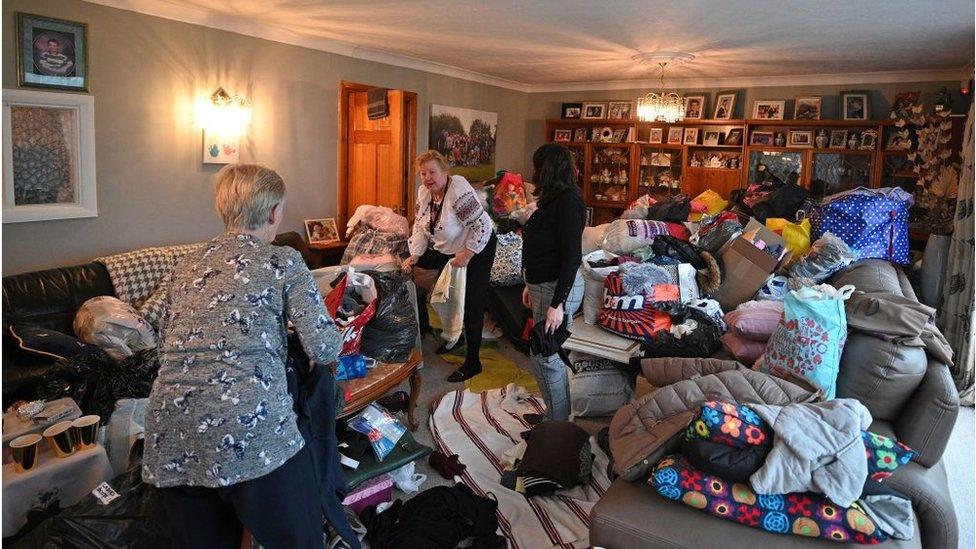 Volunteers sort through donations made following an appeal for items for Ukrainians displaced by the invasion on their country by Russia, at a residential house in Halifax, northern England, on March 2, 2022.