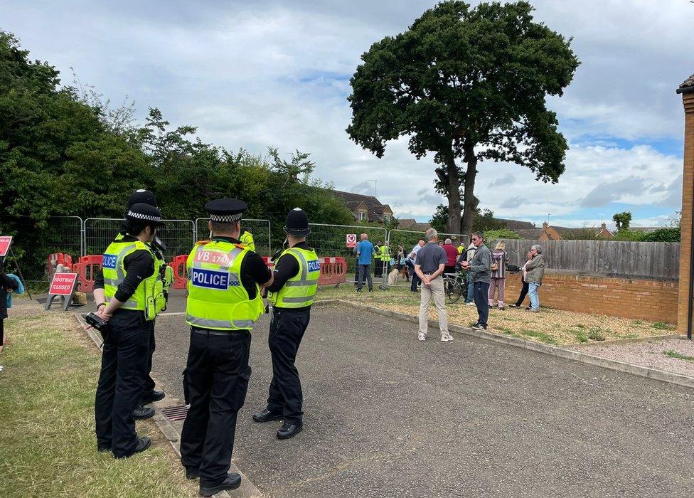 Police and protesters near the oak tree