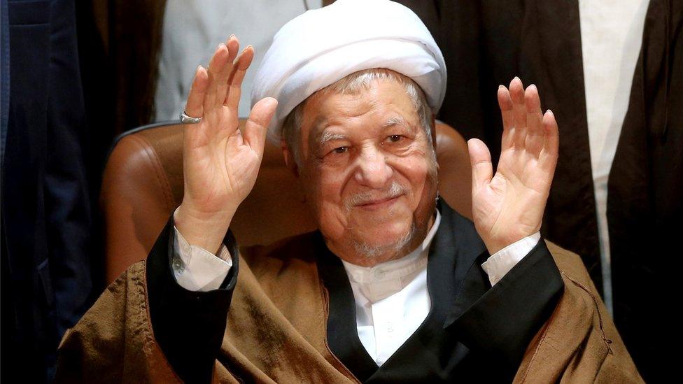 In this Dec. 21, 2015 file photo, former Iranian President Akbar Hashemi Rafsanjani waves to journalists as he registers his candidacy for the elections of the Experts Assembly, in Tehran, Iran. Iranian media said Sunday, Jan. 8, 2017,