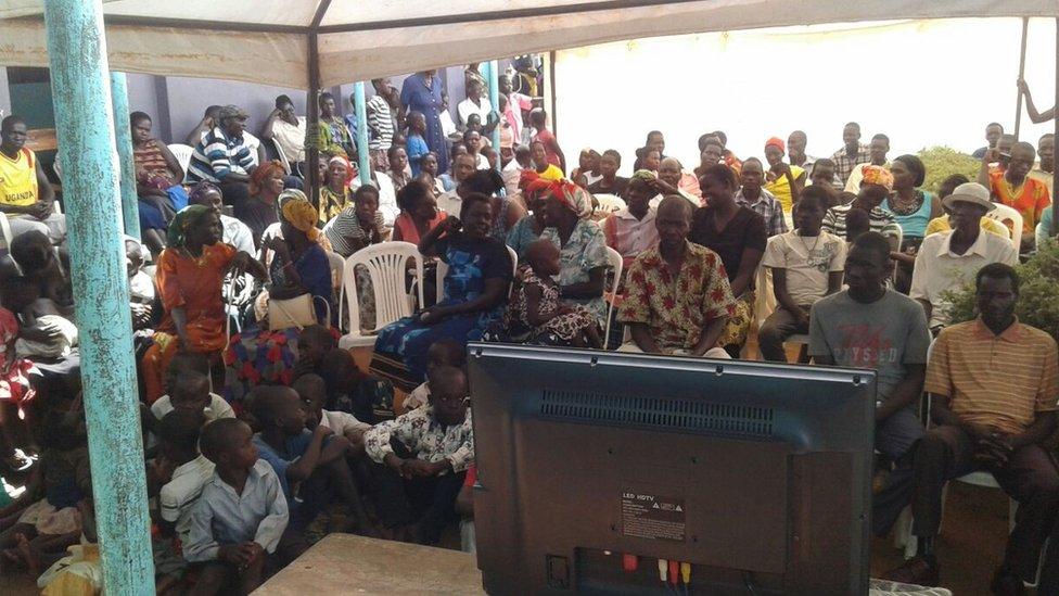 Villagers in Lukodi, scene of one of the attacks Mr Ongwen is accused of, watch his trial