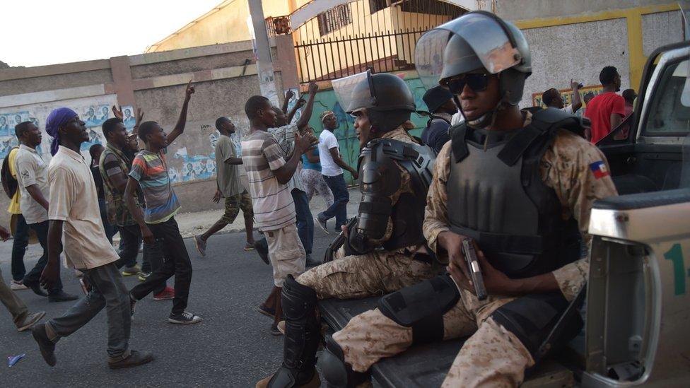 Haitian police patrol during a march by supporters of presidential candidate Maryse Narcisse in Port-au-Prince, on November 28, 2016