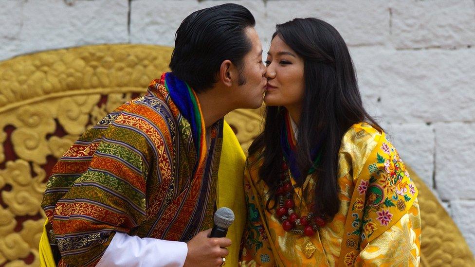 The king of Bhutan and his wife share a kiss