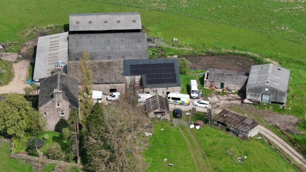 Police vans at farm