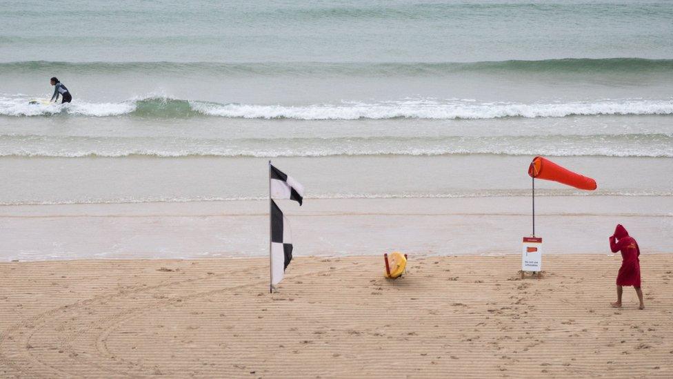 A lifeguard at a beach in windy conditions