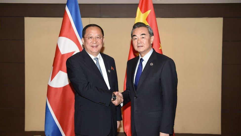 China's Foreign Minister Wang Yi (R) shakes hands with North Korea's Foreign Minister Ri Yong Ho (L) during their bilateral meeting on the sidelines of the Association of Southeast Asian Nations (ASEAN) regional security forum in Manila