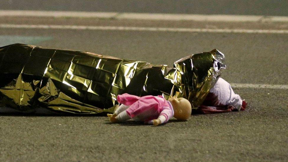 A body is seen on the ground July 15, 2016 after a truck ran into a crowd celebrating the Bastille Day national holiday July 14.