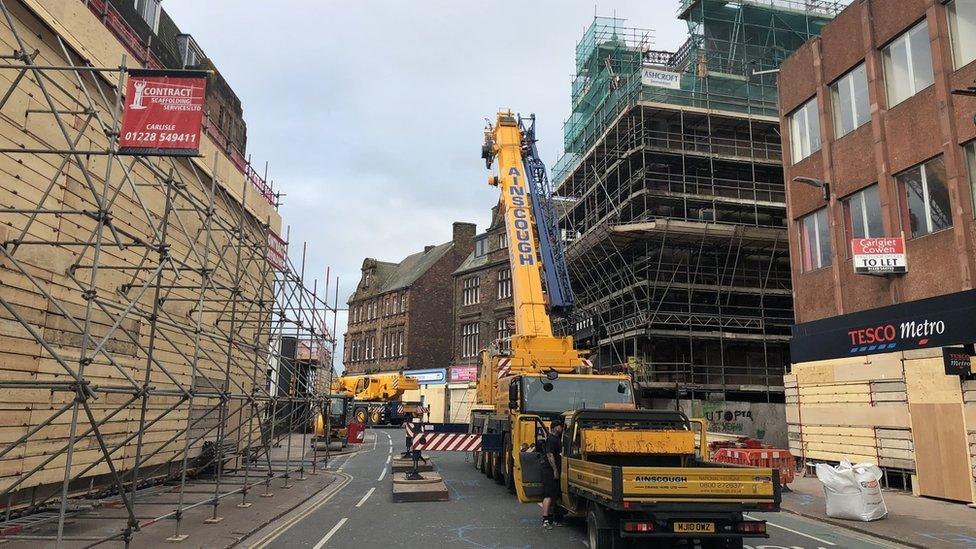 Construction teams work on the derelict Central Plaza Hotel