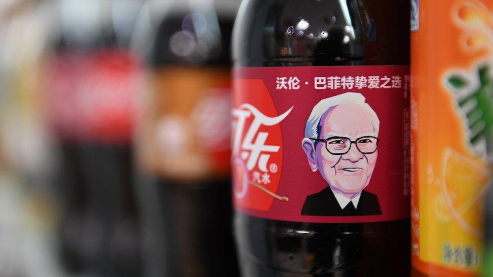 A Cherry Coke bottle featuring an image of US investor Warren Buffet is seen on a shelf at a convenience store in Beijing on April 5, 2017. The likeness of billionaire Warren Buffett has graced Cherry Coke cans in China, where the company's largest investor enjoys a legendary reputation.