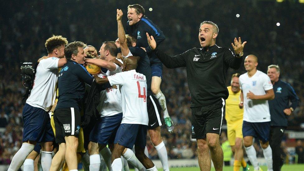 Robbie Williams and his team celebrate after winning the Soccer Aid charity cup