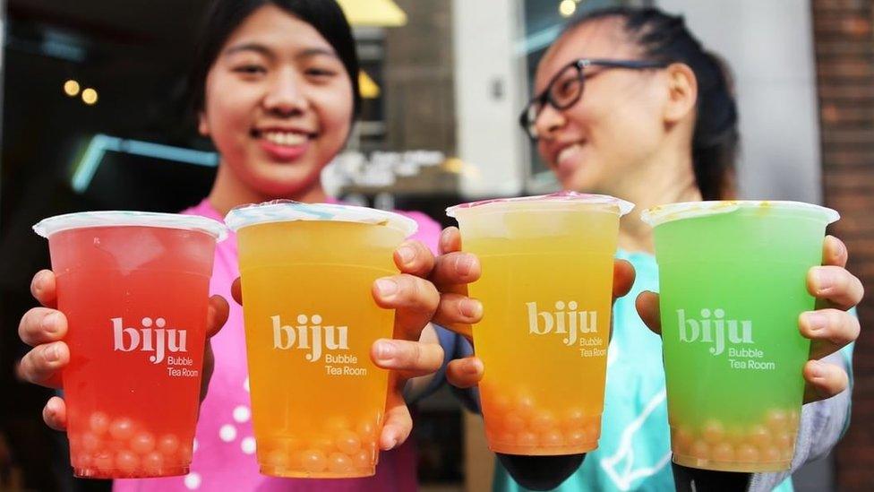 Two girls holding Biju bubble teas