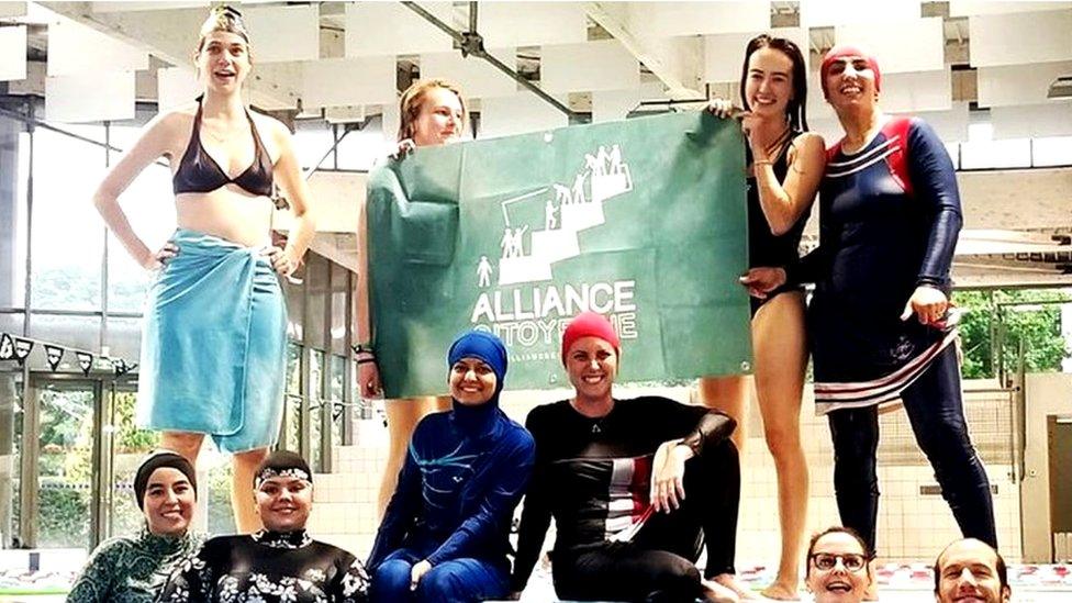 Members of the campaign group Citizen Alliance of Grenoble protest at a community pool in Grenoble, France in 2019