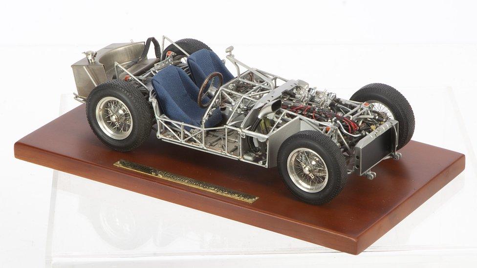 A model car on a wooden display board