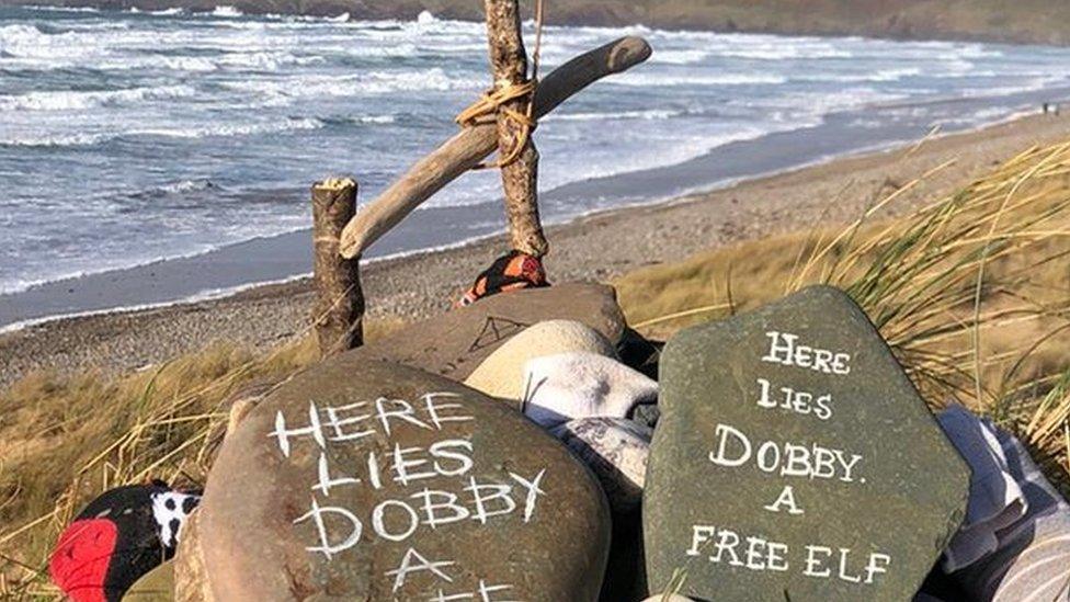 Pebbles and grave stone at Freshwater West