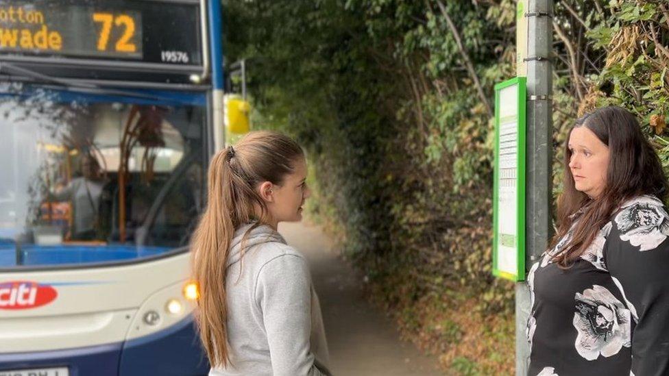 Emily and Clare Sheterline by a bus