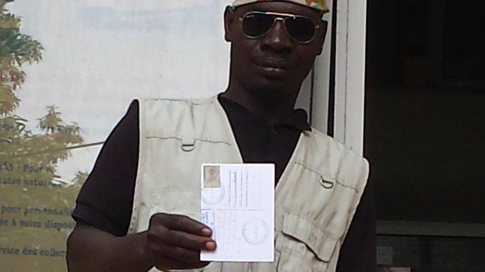 Hadji holding a postcard