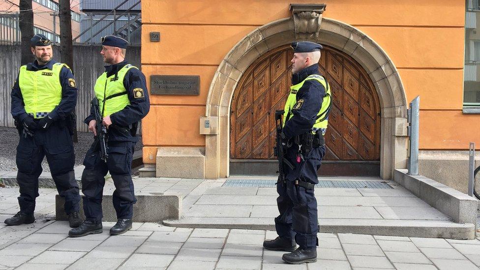 Swedish police standing guard outside the court