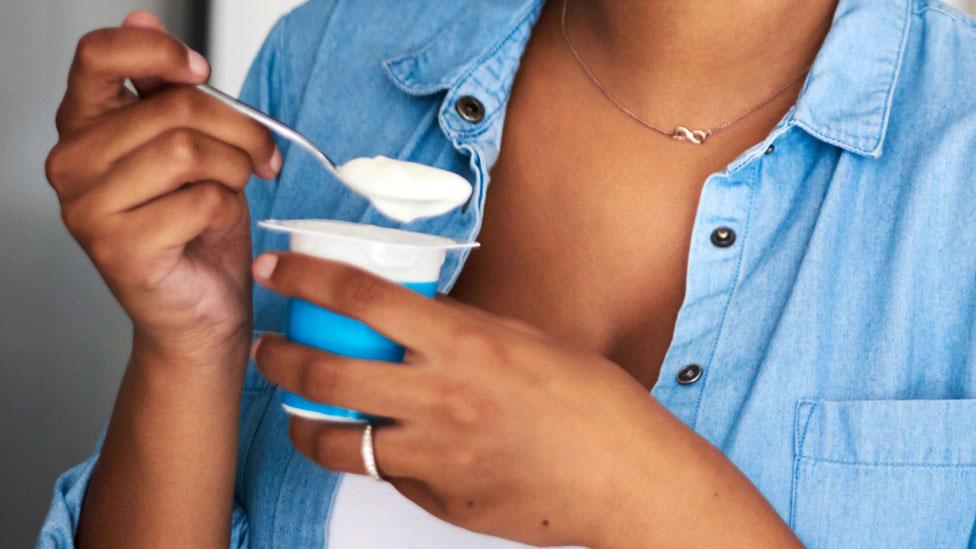 Woman eating yoghurt