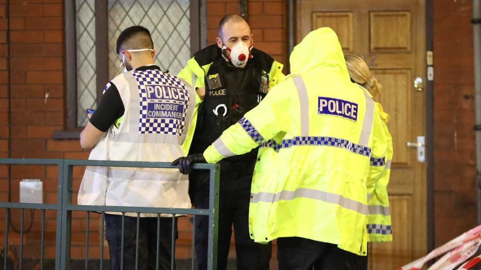 Police talk to residents as they are evacuated during the fire