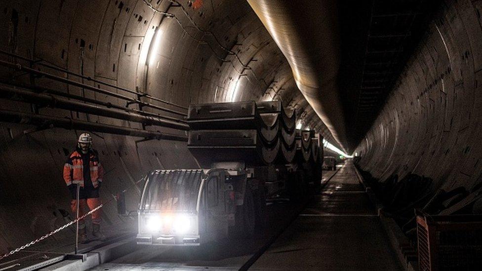 A worker stands at the construction site of a tunnel for the high-speed train line TAV (Treno Alta Velocita) between Lyon and Turin