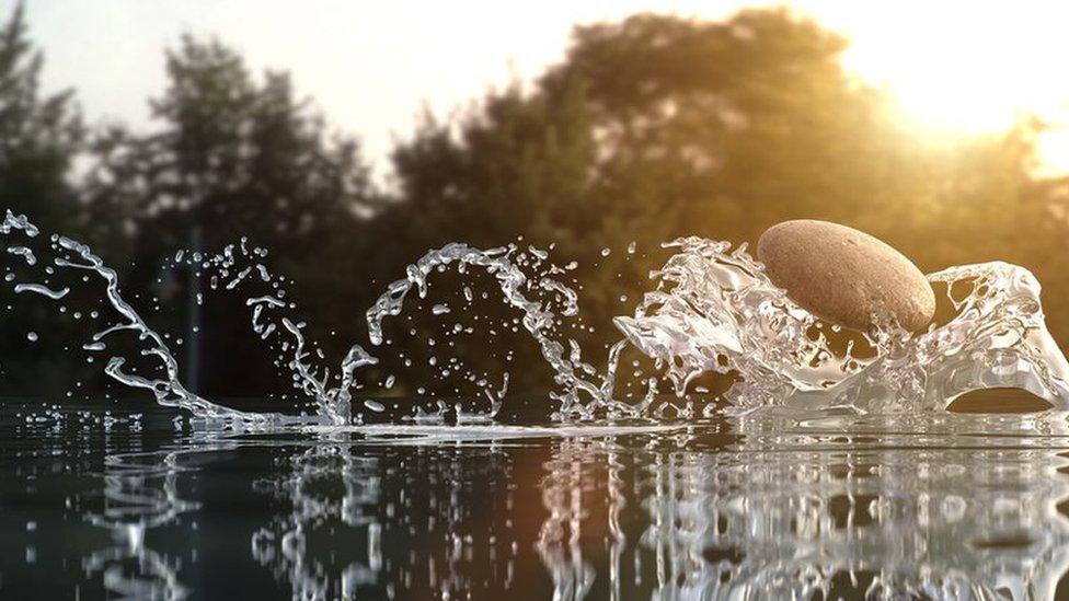 Stone skimming across the water