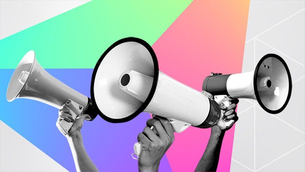 Hands holding up megaphones against a colourful background