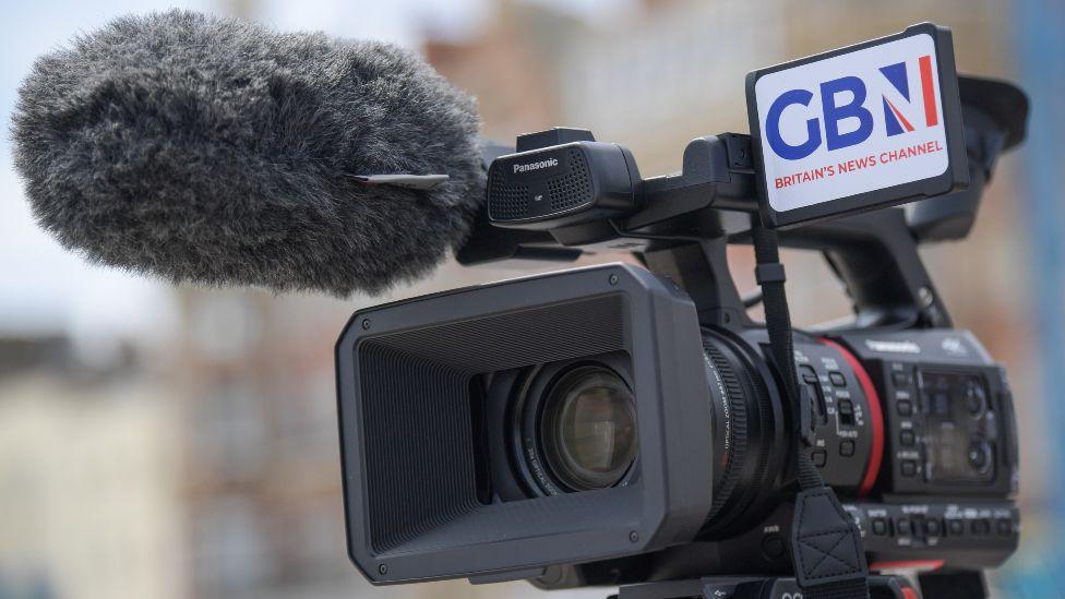 A GB News journalist conducts a live interview on the promenade on June 24, 2021 in Weymouth, United Kingdom. GB News was launched on 13 June 2021 and is a British free-to-air television news channel.