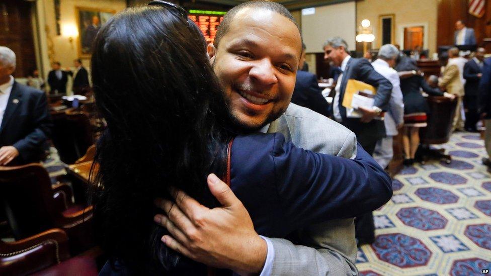 State Rep. John King, right, hugs a woman after the House approved a bill removing the Confederate flag from the Capitol grounds.