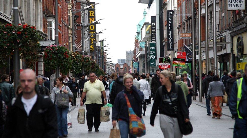 Shoppers walk down Henry Street in Dublin