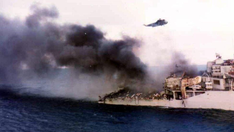 Smoke billows from HMS Ardent after it was hit by Argentinian aircraft