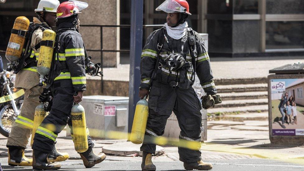 Firefighters prepare to access the Bank of Lisbon building in Johannesburg, South Africa