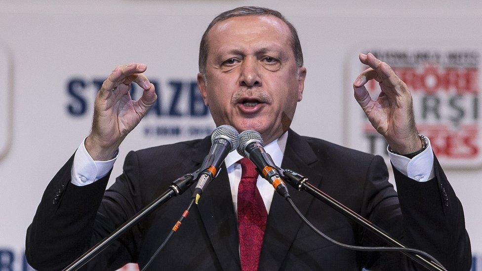 Turkey"s President Recep Tayyip Erdogan gestures as he speaks to supporters of his ruling Justice and Development Party as they rally to denounce violence by Kurdish rebels