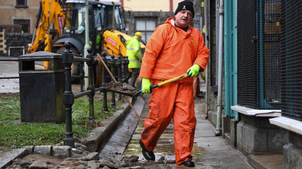 Worker clearing up the wreckage in Aberdare