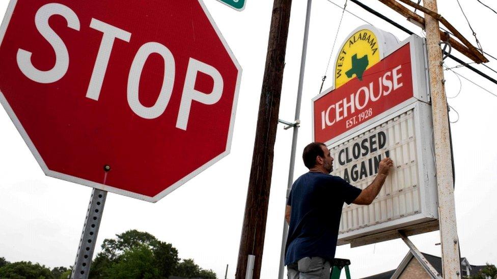 Bar owner Petros Markantonis changes the marquee outside his bar to "Closed Again" at the West Alabama Ice House in Houston, Texas, 26 June 2020