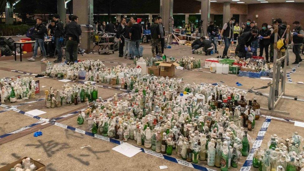 Police inspecting petrol bombs