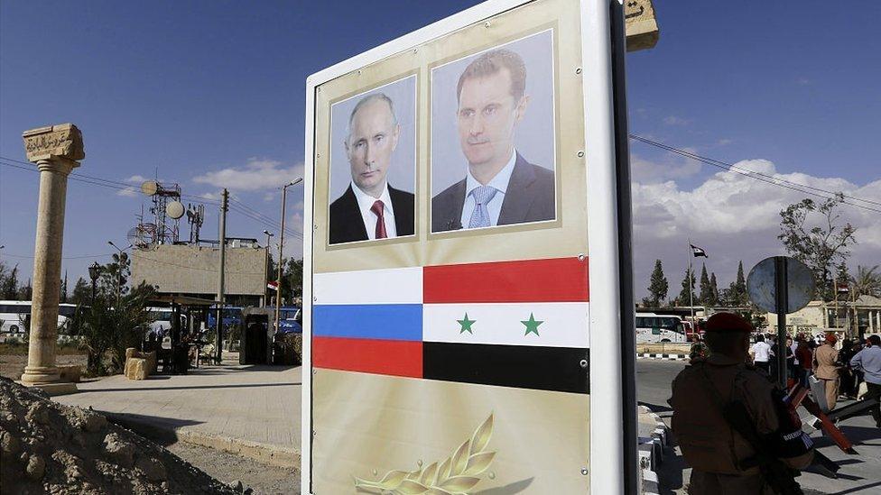 A poster bearing a portrait of Syrian President Bashar al-Assad (R) and Russian President Vladimir Putin is seen ahead of a music concert in the ancient theatre of Syria's ravaged Palmyra on May 6 2016.