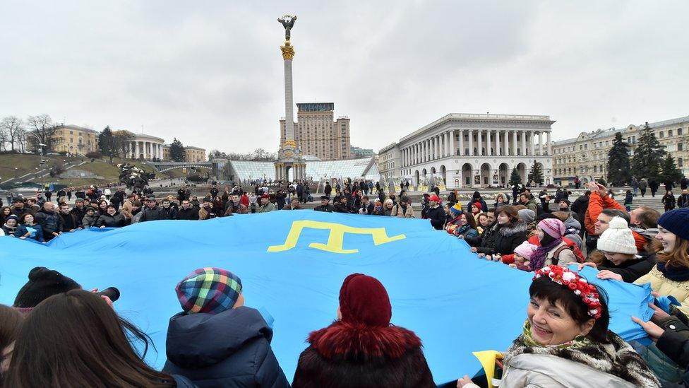 A Crimean Tatar flag is waved in the centre of Kiev in 2015