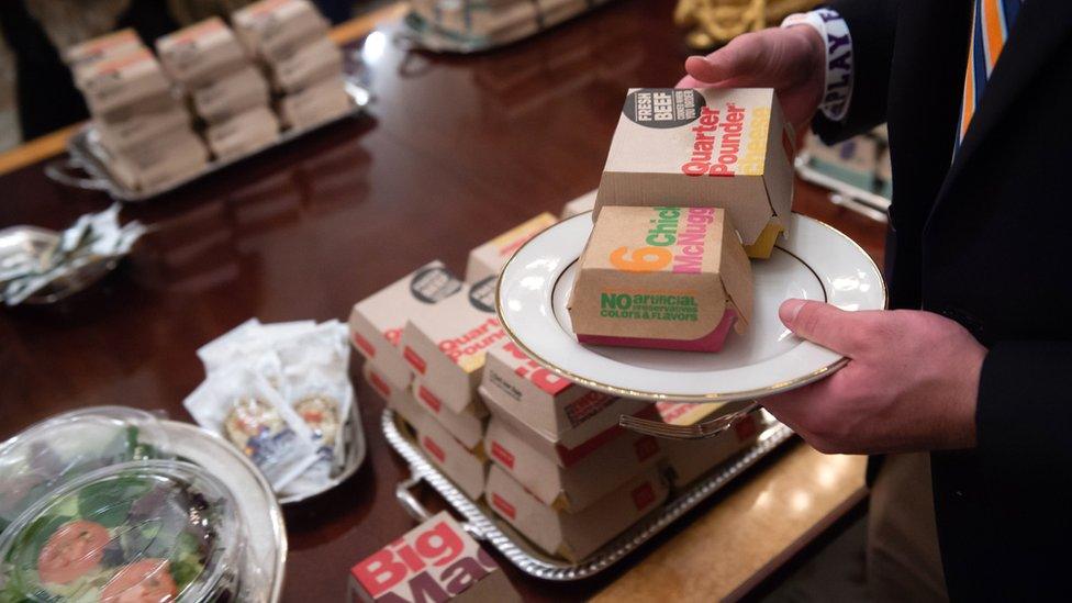 A Clemson Tiger player picks up food