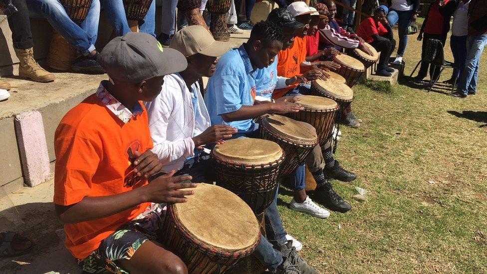 In Johannesburg, a group of men gather in an a workshop to teach men how to treat women