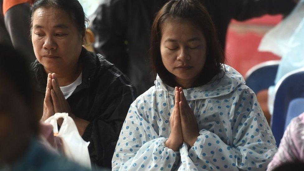 Relatives praying