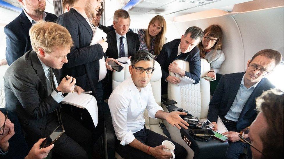 Prime Minister Rishi Sunak holds a huddle with political journalists on board a government plane as he heads to Japan to attend the G7 summit in Hiroshima